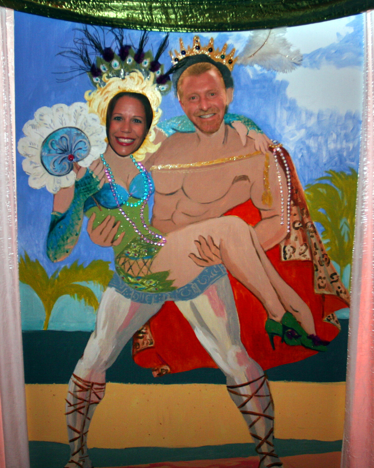 Face-in-hole photo board, tropical couple with palm leaf in warm coral tones, by Maureen Fulgenzi
