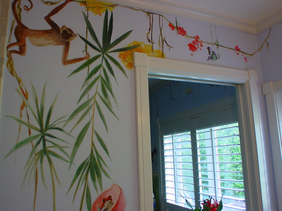 Hand-painted vine and branch border mural with monkey and tropical flowers above a doorway by Maureen Fulgenzi, Palm Beach, FL
