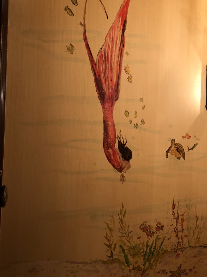 Mermaid diving mural in a powder room with pedestal sink by Maureen Fulgenzi, Palm Beach, FL