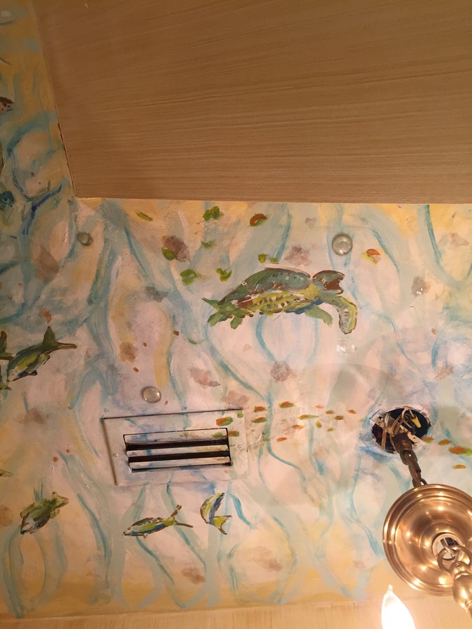 Mermaid mural detail above a bathroom vent and sconce, Palm Beach, FL