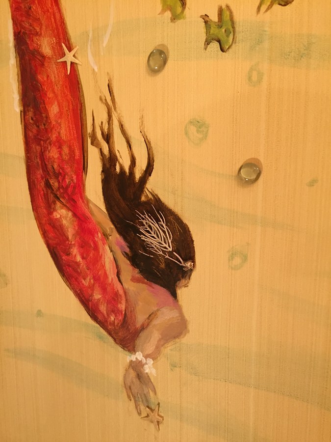 Red-tailed mermaid mural detail with dark flowing hair, Palm Beach, FL