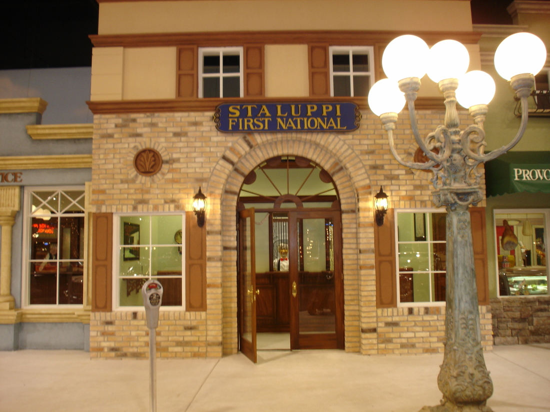 First National bank storefront facade mural with street lamp, car museum backdrop, Palm Beach, FL