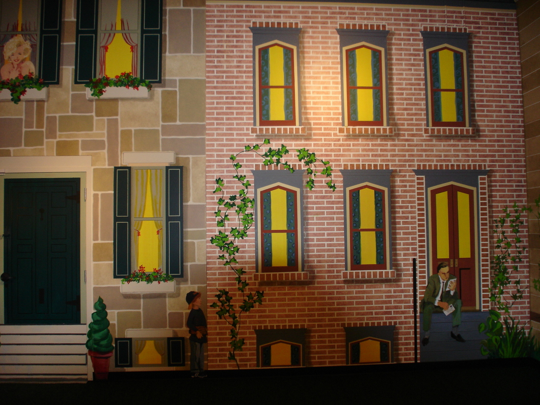 Brick townhouse facade mural with yellow-lit windows, car museum backdrop, Palm Beach, FL
