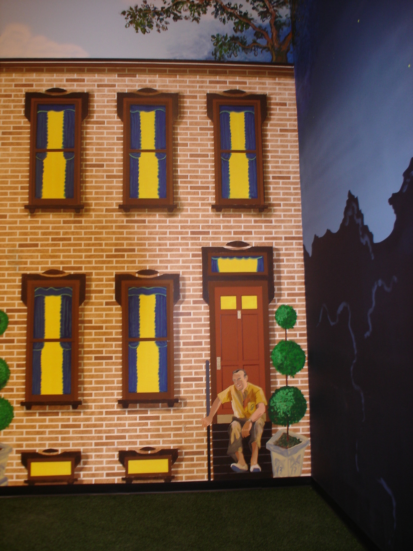 Brick rowhouse facade mural with red door and painted figure, car museum backdrop, Palm Beach, FL
