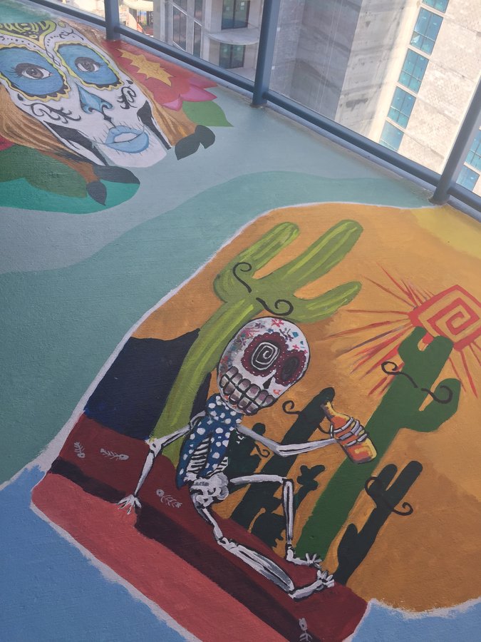 Second view of the toasting skeleton figure and cactus scene, exterior terrace mural, Palm Beach, FL