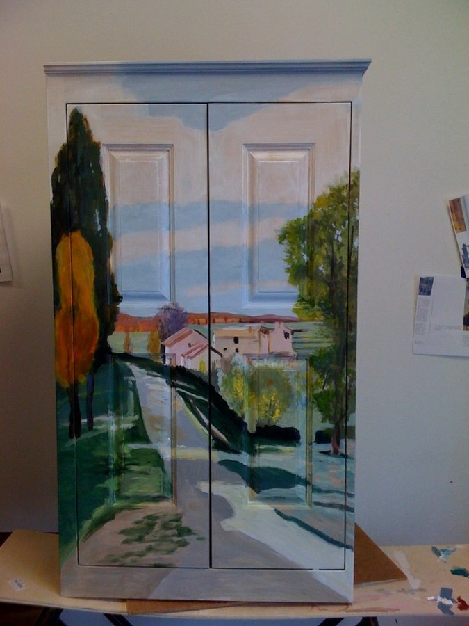Trompe l'oeil village scene mural painted on a wardrobe cabinet by Maureen Fulgenzi — Warm palette, Palm Beach, FL