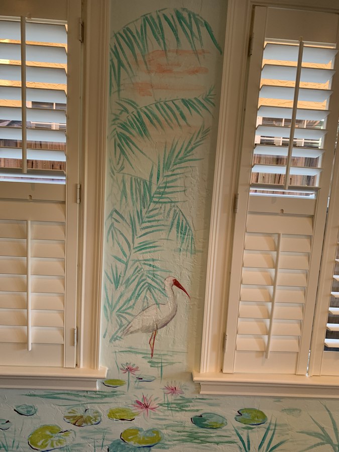 Tropical foliage mural detail beside shutters with red bird, Palm Beach, FL