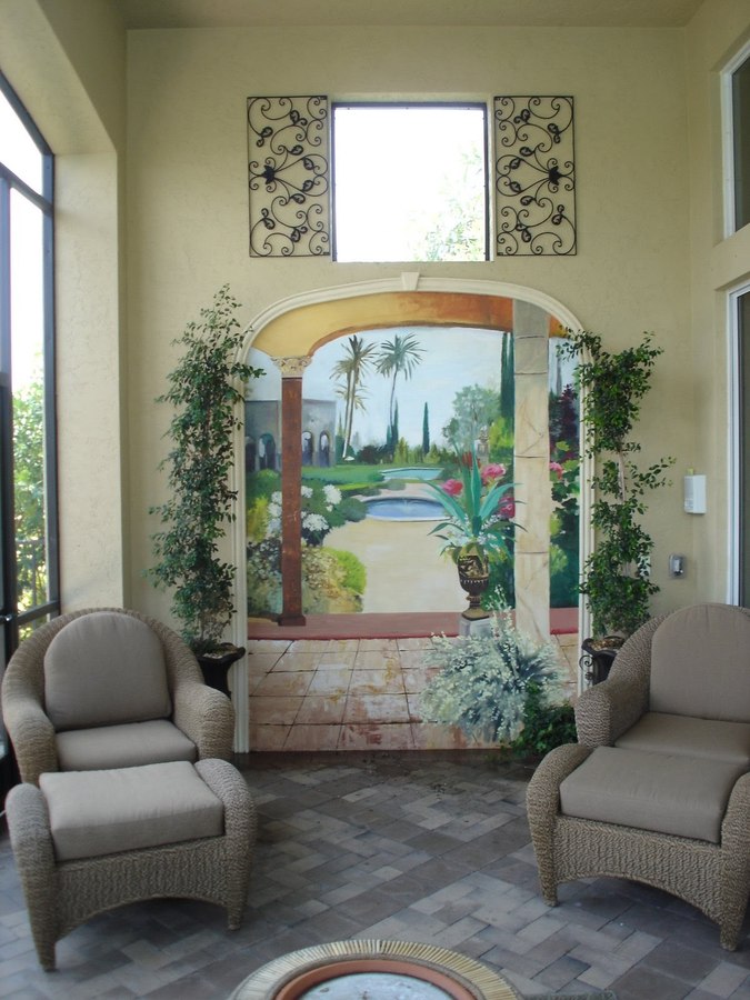 Garden and fountain mural niche room view with wicker seating, Palm Beach, FL
