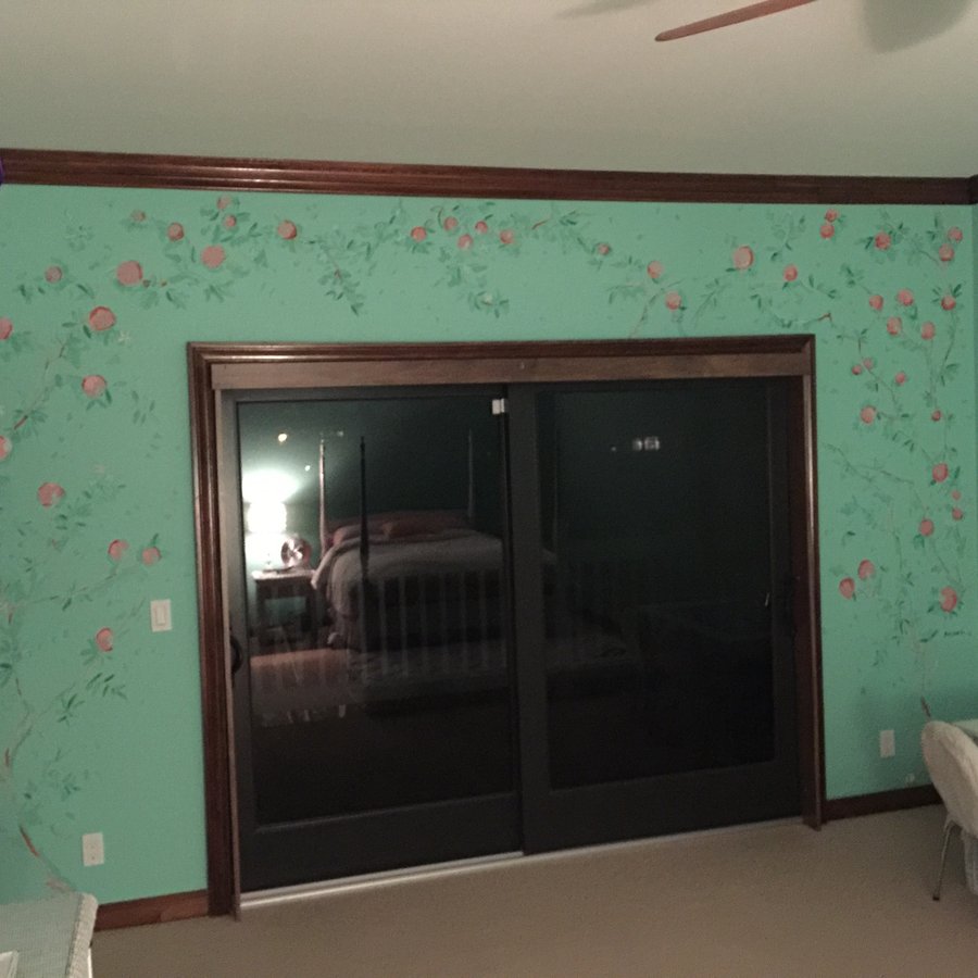 Wide view of the green chinoiserie rose branch mural wrapping a bedroom with sliding glass doors, Palm Beach, FL