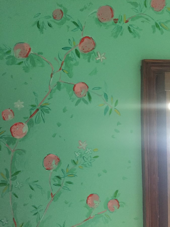 Rose branch mural detail beside a dark wood door frame, Palm Beach, FL