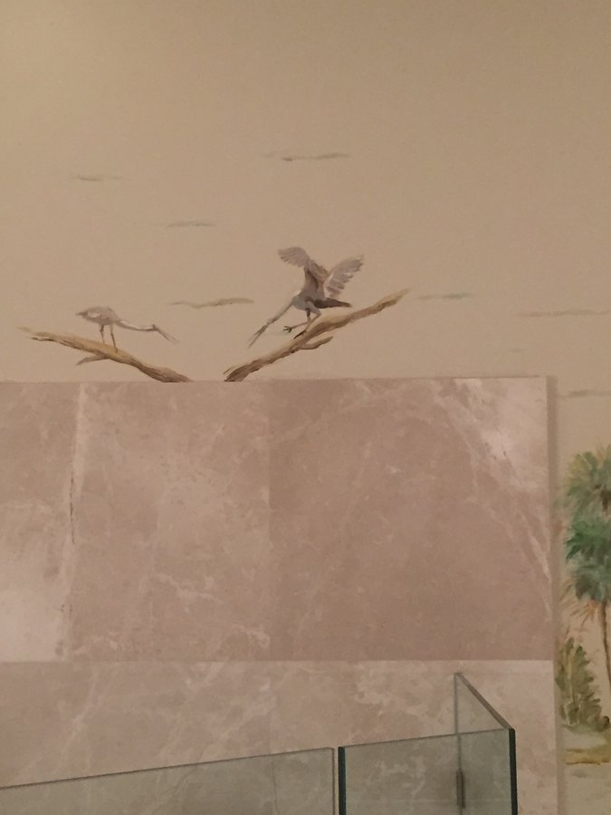 Sailboats and harbor mural detail with wading birds above pink marble tile, Palm Beach, FL