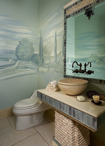 Wide powder room view of the grey-green Tuscan village mural above a stone vanity, Palm Beach, FL