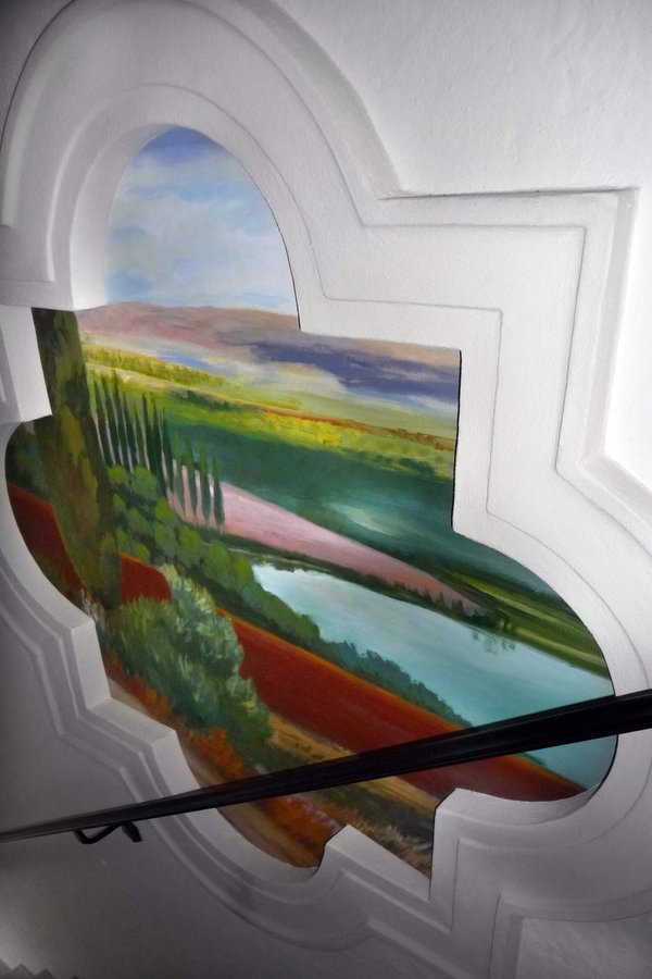 Tuscan field mural in the stairwell niche with handrail crossing the view, Palm Beach, FL