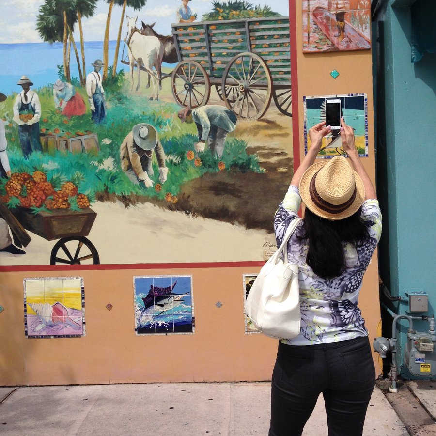 Full Stuart mural with a visitor photographing the artwork on her phone, Palm Beach, FL