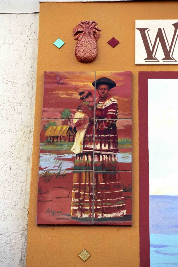 Corner tile and painted-figure detail beside the Stuart mural, traditional dress figure, Palm Beach, FL