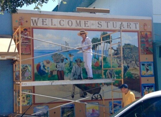 Scaffolding view of the Stuart mural in progress beside a tree, street below, Palm Beach, FL