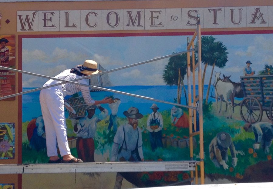 Maureen Fulgenzi on scaffolding painting the Stuart mural, close view, Palm Beach, FL