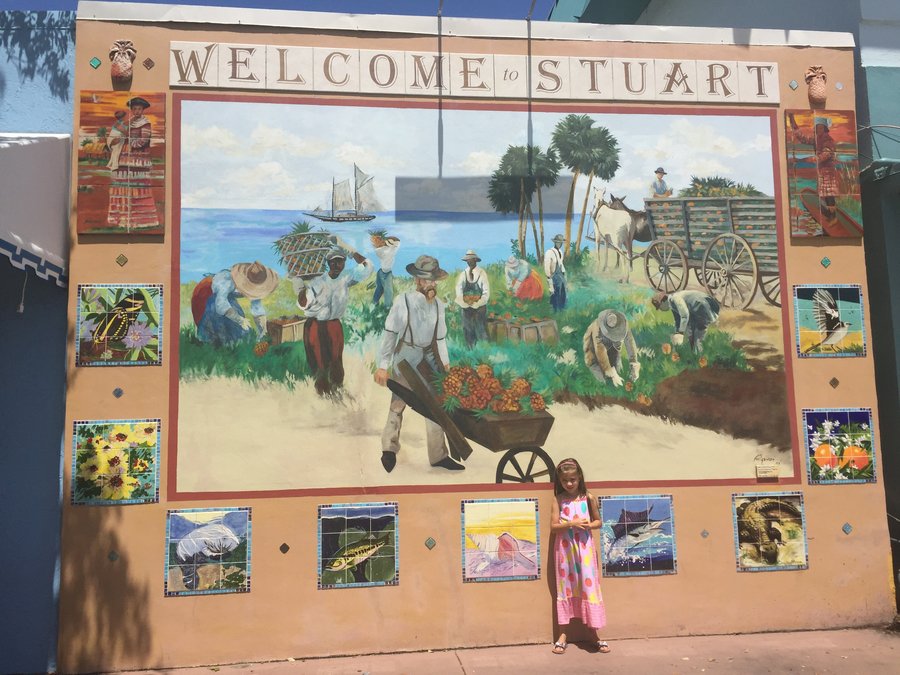 Finished Stuart mural with a mother and daughter posed for scale at the base, Palm Beach, FL