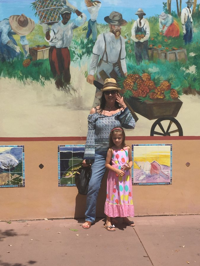 Closer view of the farm-cart and harvest figures in the Stuart mural, mother and daughter posed nearby, Palm Beach, FL