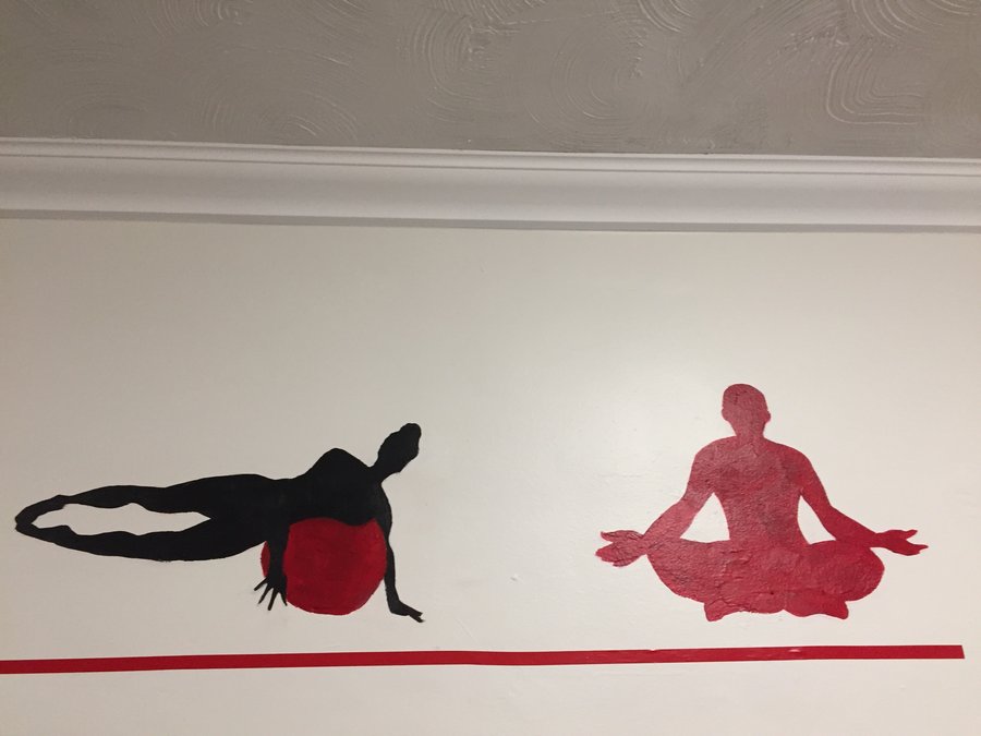 Backbend and reclining silhouette figures painted along the gym mural border, Palm Beach, FL
