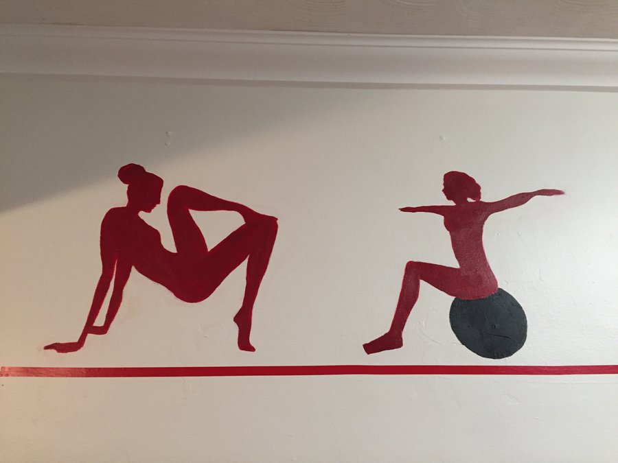 Lunge and seated silhouette figures painted along the gym mural border, signed by the artist, Palm Beach, FL