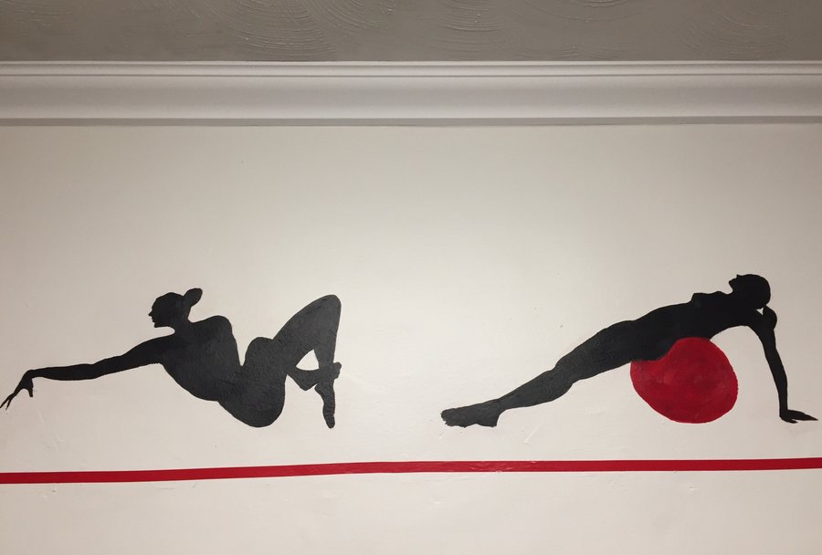 Second view of the arm-raise and stability-ball figures in the gym mural border, Palm Beach, FL