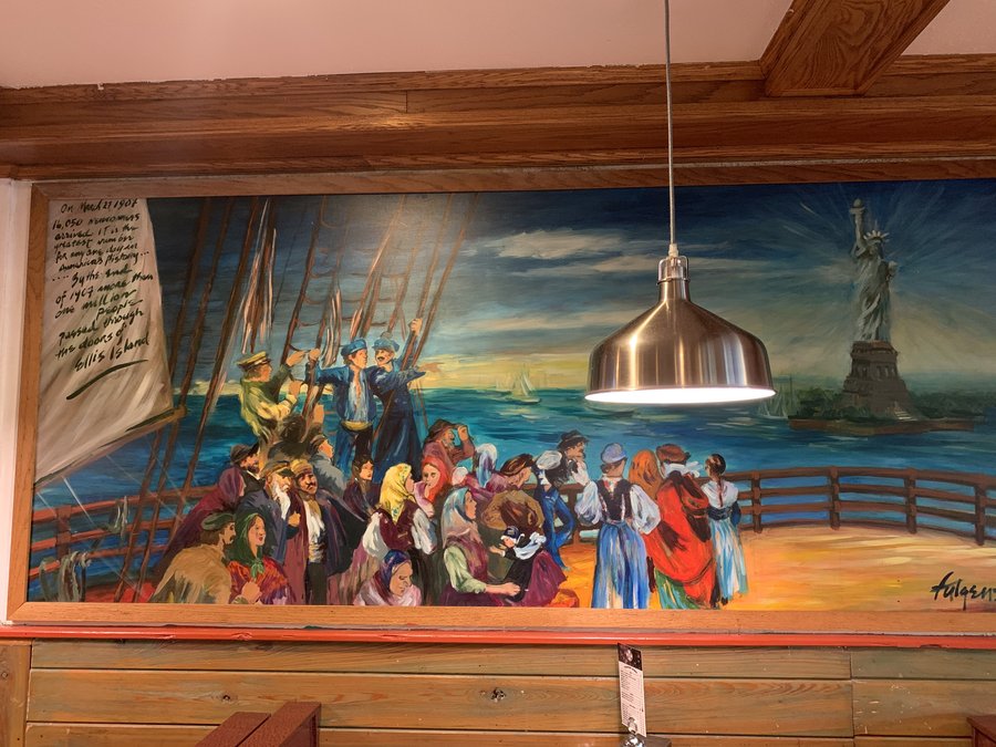 Second wide view of the Ellis Island arrival mural panel above the restaurant booths, Palm Beach, FL