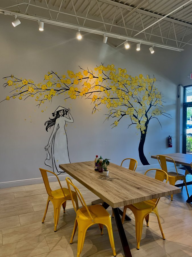 Dining room view of the finished cherry blossom mural above the wood tables, Pho and Rolls, Palm Beach, FL
