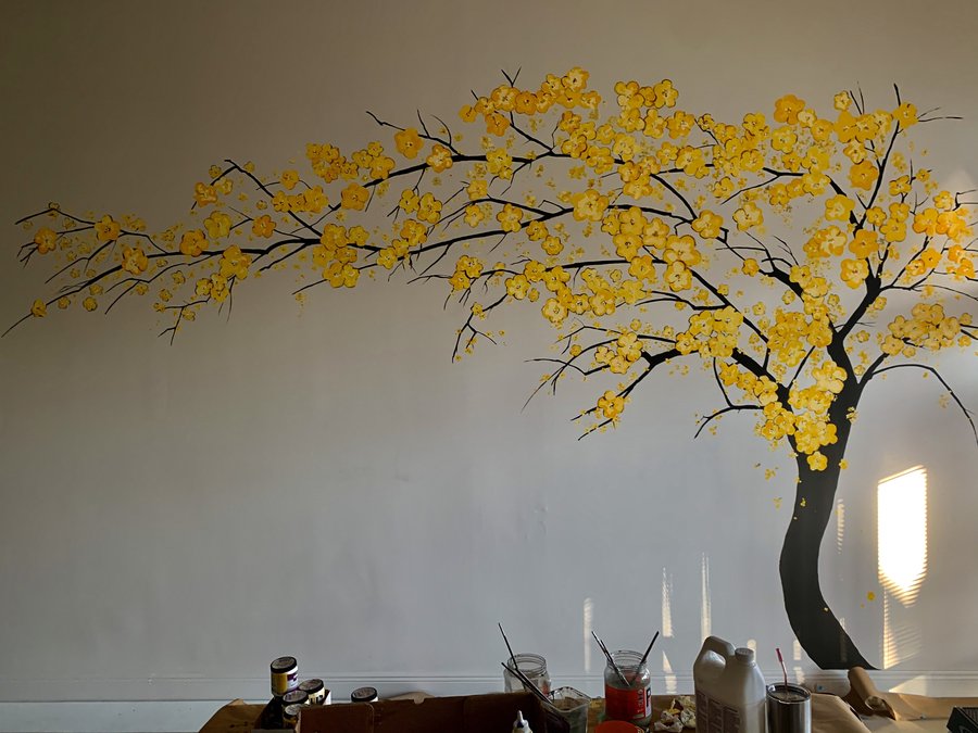 Full cherry blossom tree mural with drink bottles on the counter below, Pho and Rolls, Palm Beach, FL