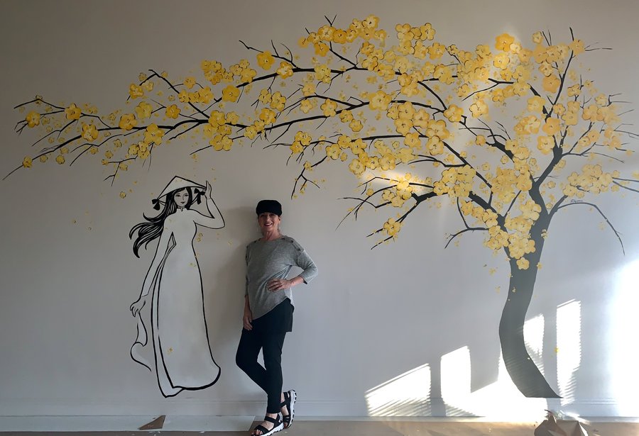 Second view of the artist posed beside the mural outline, early stage, Pho and Rolls, Palm Beach, FL