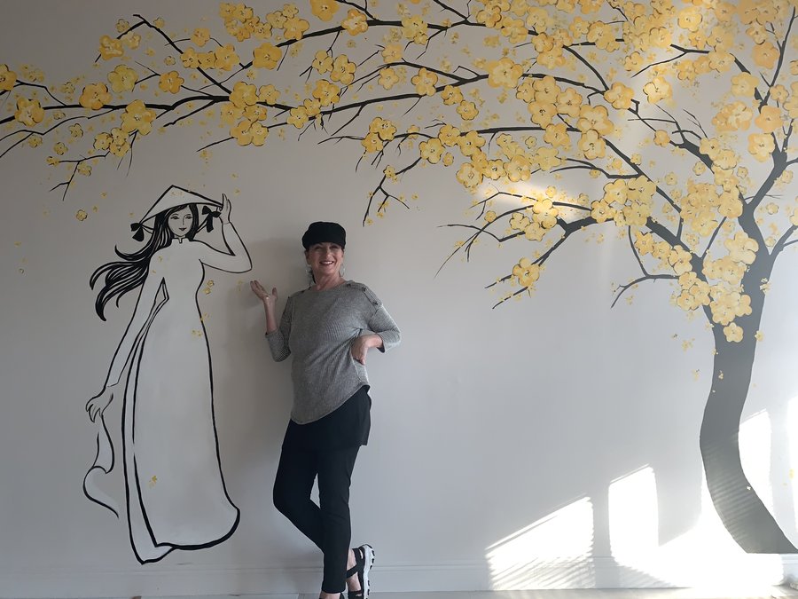 Third view of the artist posed beside the mural outline, early stage, Pho and Rolls, Palm Beach, FL