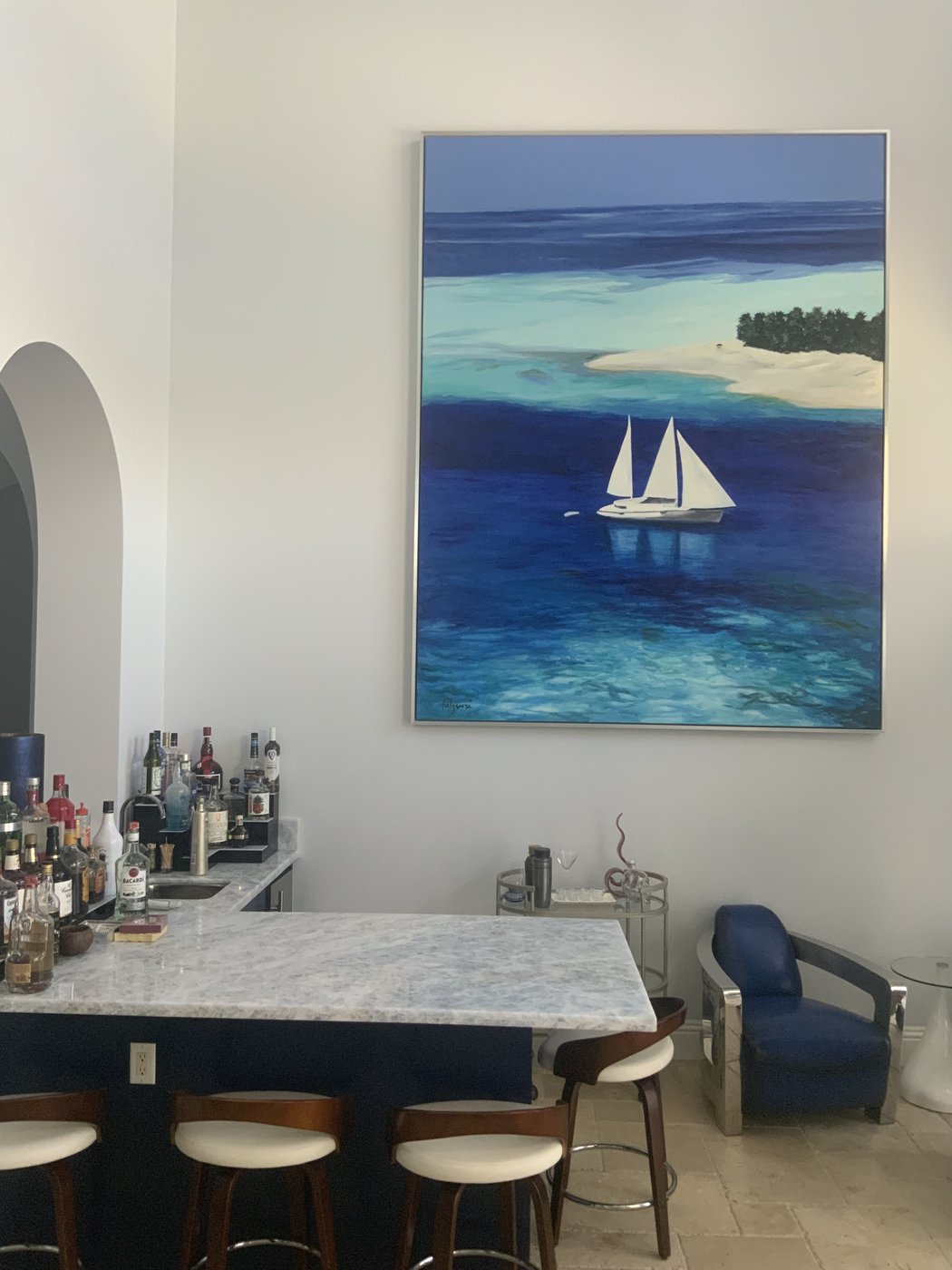 Sailboat seascape painting by Maureen Fulgenzi above a home wet bar with marble counter, Palm Beach, FL