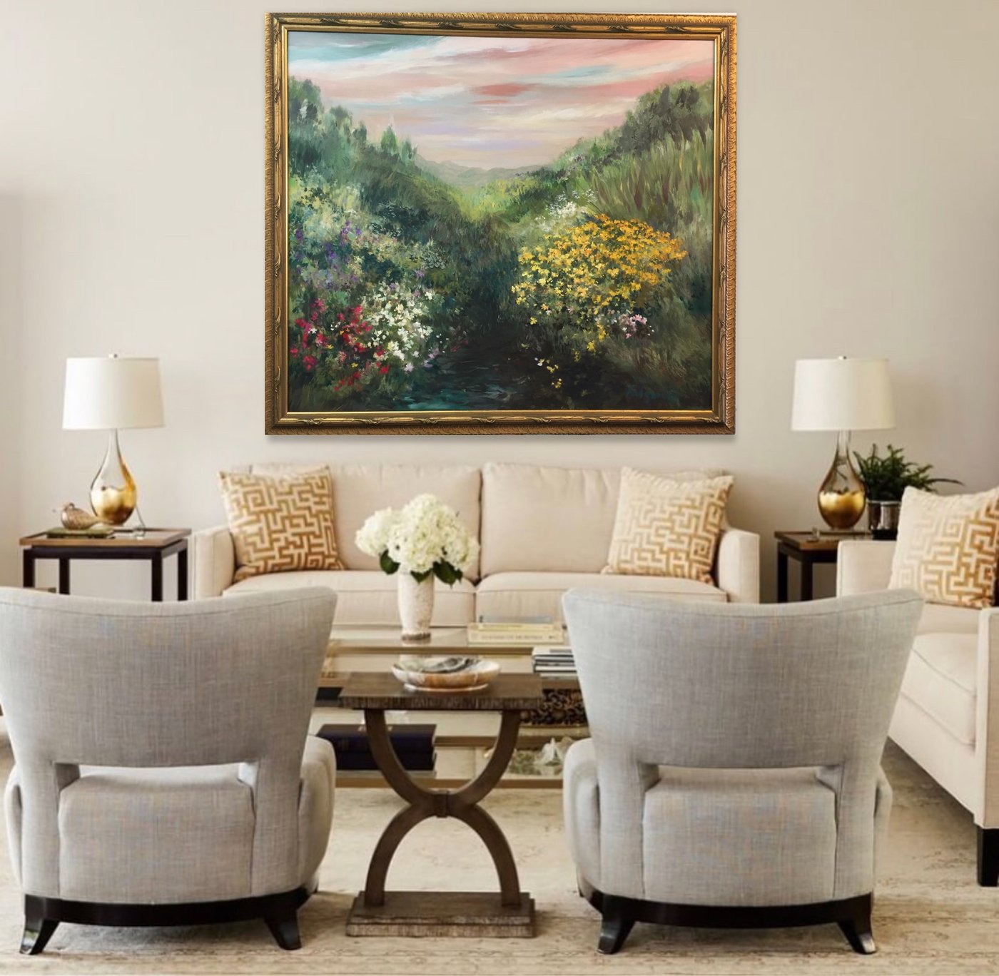 Realistic landscape painting by Maureen Fulgenzi in a gold frame above a sofa in a neutral Palm Beach living room