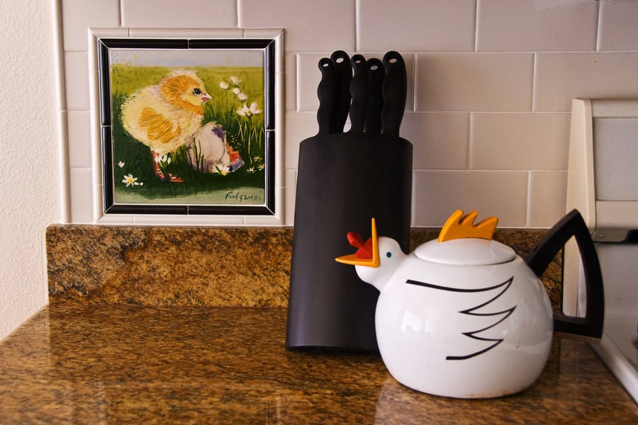 Same baby chick hand-painted tile, kitchen backsplash detail view, by Maureen Fulgenzi — Yellow & white palette, Palm Beach, FL