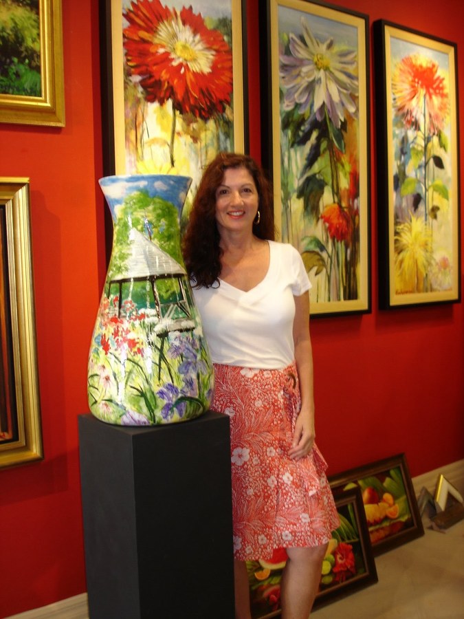 Same hand-painted vase, gallery photo showing the garden trellis side, by Maureen Fulgenzi — Vivid multicolor palette, Palm Beach, FL